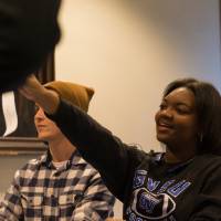 Image of student workers passing out first gen day goodies at sign in table